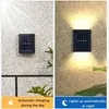 A split image showing a solar outdoor lamp mounted on a textured wall. The left side shows the lamp during the day with sunlight, indicating it's charging. The right side shows the lamp at night, illuminated and casting light upwards and downwards. Náhľad obrázku produktu