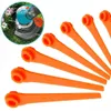 A collection of orange plastic trimmer blades arranged in a fan shape, with a close-up inset image of a grass trimmer head in the upper left corner. Produktbild-Vorschau