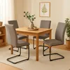 A dining room setting with a wooden table and four chairs. Produktbild-Vorschau