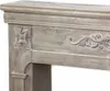 Close-up view of a decorative wooden fireplace mantel with carved details and a distressed, whitewashed finish. Anteprima dell’immagine prodotto