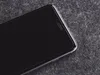 A close-up shot of a smartphone screen and its edge, placed on a textured gray surface. Produktbild-Vorschau