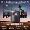 A portable projector is shown in a desert-like environment, projecting a screen with various streaming service logos and movie posters. Náhled obrázku produktu
