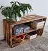A wooden crate shelf unit with a plant, decorative boxes, and books. Náhled obrázku produktu