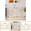 A wooden bar table and two bar stools are arranged on a rug in a room. Produktbild-Vorschau