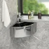 A corner sink with a faucet and a towel hanging on the wall, with bottles on a shelf above. Náhled obrázku produktu