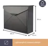 A dark gray mailbox with dimensions and weight indicated by text and graphics. Voir les images du produit