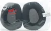 Two black ear pads are shown in clear plastic packaging. Podgląd zdjęcia produktu