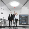 Three people walking in an office hallway with a ceiling light. Produktbild-Vorschau
