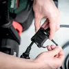 A close-up shot of hands connecting a black cable to a black device with the Metabo logo. Voir les images du produit