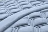A close-up, angled view of a light gray, textured car seat cover. Produktbild-Vorschau