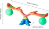 A colorful children's seesaw with green balls on each end, set against a white background. Dimensions are indicated by measurement lines and text. Produktbild-Vorschau