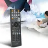 A person is sitting on a chair and holding a remote control, watching a TV with a whale on it. Produktbild-Vorschau