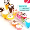 A collection of colorful, toy-like dessert creations, possibly made from slime or modeling clay, arranged on a white background. Voir les images du produit