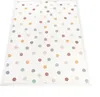 A flat lay image of a round rug with a polka dot pattern. Produktbild-Vorschau