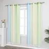 Two gradient curtains with white star patterns hanging on a curtain rod in front of a window. Produktbild-Vorschau