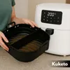 A person is holding a black silicone air fryer insert next to a white air fryer. Náhled obrázku produktu