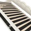 Close-up view of the slatted base of a white upholstered bed frame. Produktbild-Vorschau