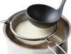 A ladle is pouring a creamy liquid into a sieve that is placed over a pot. Anteprima dell’immagine prodotto