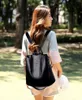 A woman wearing a backpack in an outdoor setting. Náhľad obrázku produktu