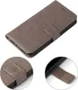 A gray flip cover phone case with a floral embossed pattern. Produktbild-Vorschau