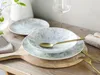 A table setting with plates, bowls, and cutlery on a wooden board. Náhľad obrázku produktu