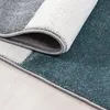A close-up view of a rolled-up rug, showing the texture and colors of the material. Voir les images du produit