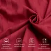 A close-up of red striped fabric with informational icons and text overlays. Produktbild-Vorschau