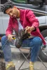 A man is cleaning a boot outdoors. Produktbild-Vorschau