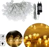 A collage of images showing LED string lights with crystal balls, a power adapter, and icons indicating IP44 water resistance and LED lighting. Náhled obrázku produktu
