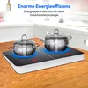 A double induction cooktop with two pots on it, set on a wooden table in a kitchen setting. Produktbild-Vorschau