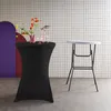 Two party standing tables, one with a black stretch cover and flowers, and another white table with a metal frame, set against a tiled wall. Produktbild-Vorschau