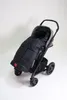 A black Kaiser Iglu Thermo Fleece is shown in a stroller against a white background. Produktbild-Vorschau
