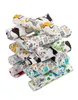 A stack of rolled-up baby burp cloths with various animal and house prints. Produktbild-Vorschau