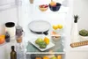 Inside of a refrigerator with various food items and containers. Voir les images du produit