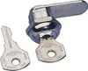 A close-up studio shot of a mailbox lock cylinder with a key inserted and another key lying next to it. Náhled obrázku produktu