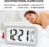 A person sleeping in bed with a digital alarm clock in the foreground. Náhled obrázku produktu