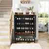 A shoe cabinet with shoes displayed on shelves, next to a staircase and a window. Anteprima dell’immagine prodotto