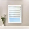 A white window blind is shown in a window, with a plant on the left. Produktbild-Vorschau
