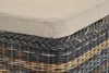 A close-up view of the top edge of a woven storage basket with a cushion on top. Produktbild-Vorschau