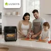 A family preparing food in a kitchen, with an air fryer on the counter. Produktbild-Vorschau