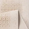 A close-up view of a beige rug with a geometric pattern. Produktbild-Vorschau
