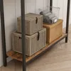 A shelf with storage boxes and a basket of towels. Produktbild-Vorschau