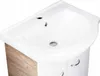A close-up, angled view of a white sink with a wood-grain cabinet below. Náhled obrázku produktu