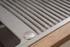 A close-up view of a stainless steel sink with a wooden countertop. Produktbild-Vorschau