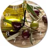 A round clock face with an image of olives and olive oil. Produktbild-Vorschau