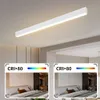 A modern white LED ceiling light fixture mounted on a ceiling above a bedroom. Náhled obrázku produktu