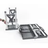 A person's hand is shown adjusting a portable picnic table and seating set against a white background. Produktbild-Vorschau