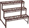 A three-tiered plant stand with ornate scrollwork on each shelf. Anteprima dell’immagine prodotto