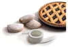 A pie and cookies are arranged on a white background with a kitchen gadget in the foreground. Náhľad obrázku produktu