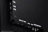A close-up view of the rear ports of a television, showing various connection types like USB and HDMI. Produktbild-Vorschau